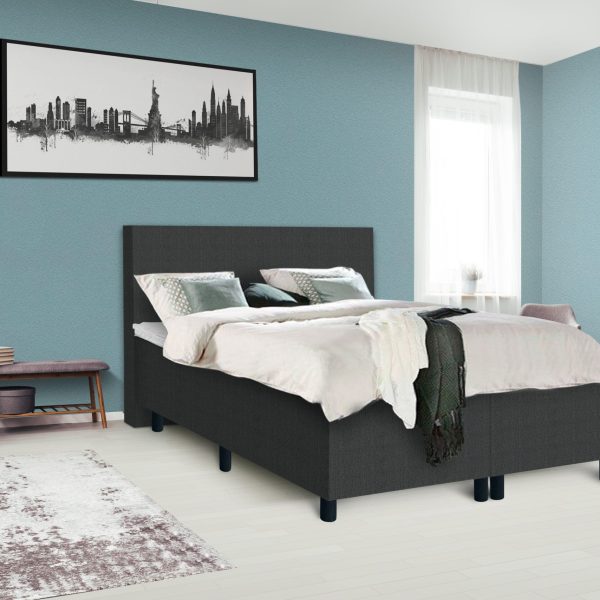 Dark poster on the wall with copy space in bright bedroom interior with bench, grey chair and patterned carpet