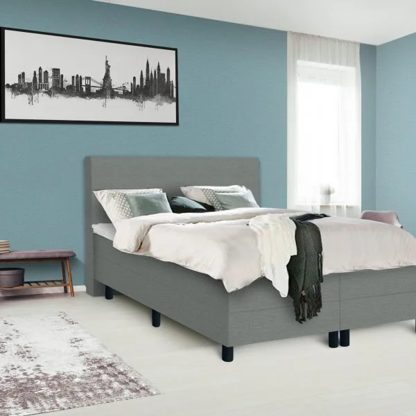 Dark poster on the wall with copy space in bright bedroom interior with bench, grey chair and patterned carpet